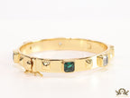 Band style bracelet in gold plating with gold plated details and multi colour stones