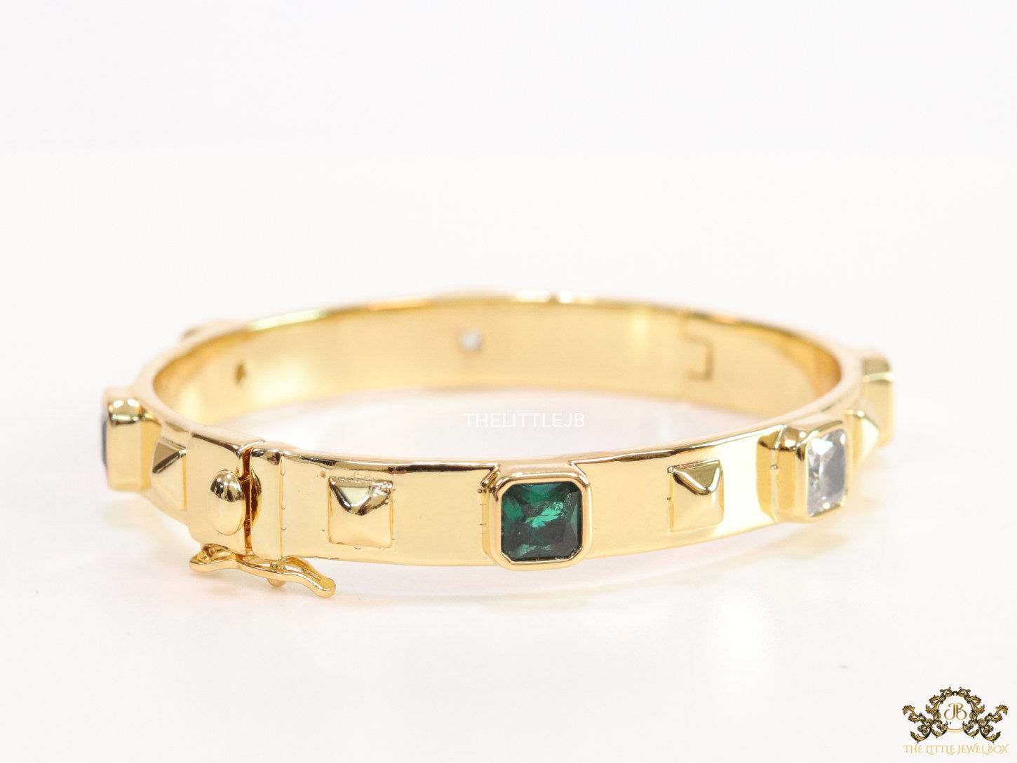 Band style bracelet in gold plating with gold plated details and multi colour stones