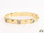 Band style bracelet in gold plating with gold plated details and cubic zirconia stones