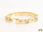 Band style bracelet in gold plating with gold plated details and cubic zirconia stones