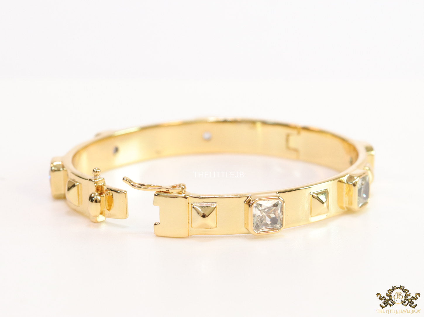 Band style bracelet in gold plating with gold plated details and cubic zirconia stones