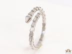Open top platinum plated minimal serpentine bracelet with cubic zirconia stones and pearl white stones.