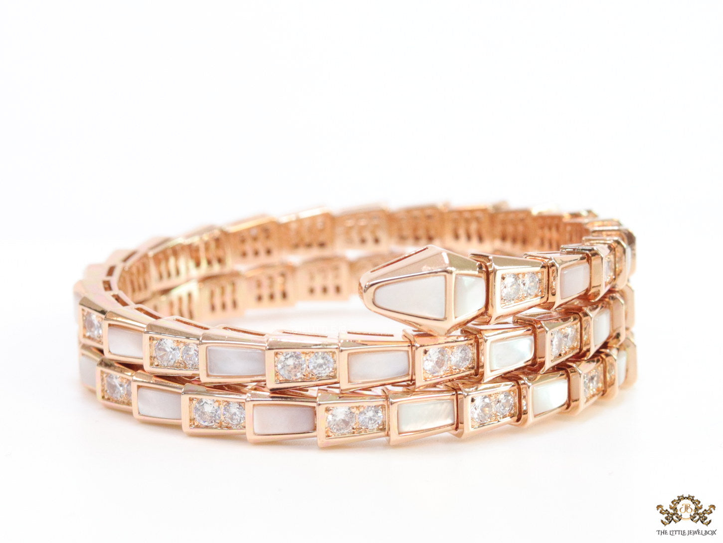 Triple line rose gold plated minimal serpentine bracelet with cubic zirconia stones and pearl white stones.