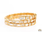 Triple line gold plated minimal serpentine bracelet with cubic zirconia stones and pearl white stones.
