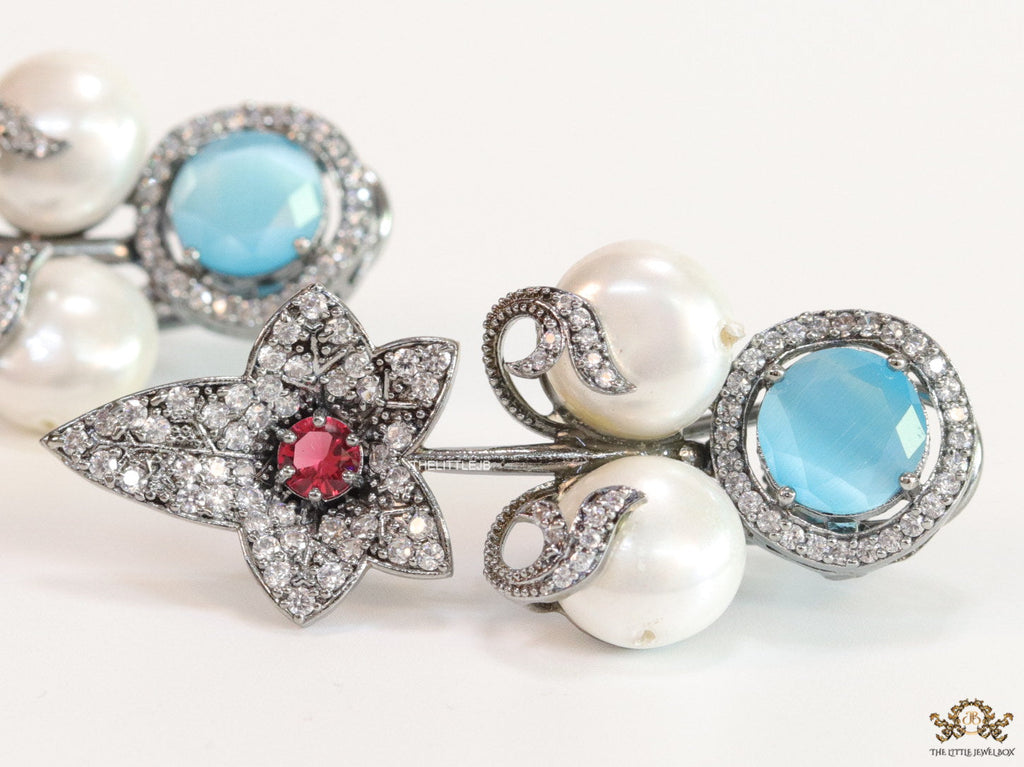 Cz flower earrings with shell pearls and light blue stones