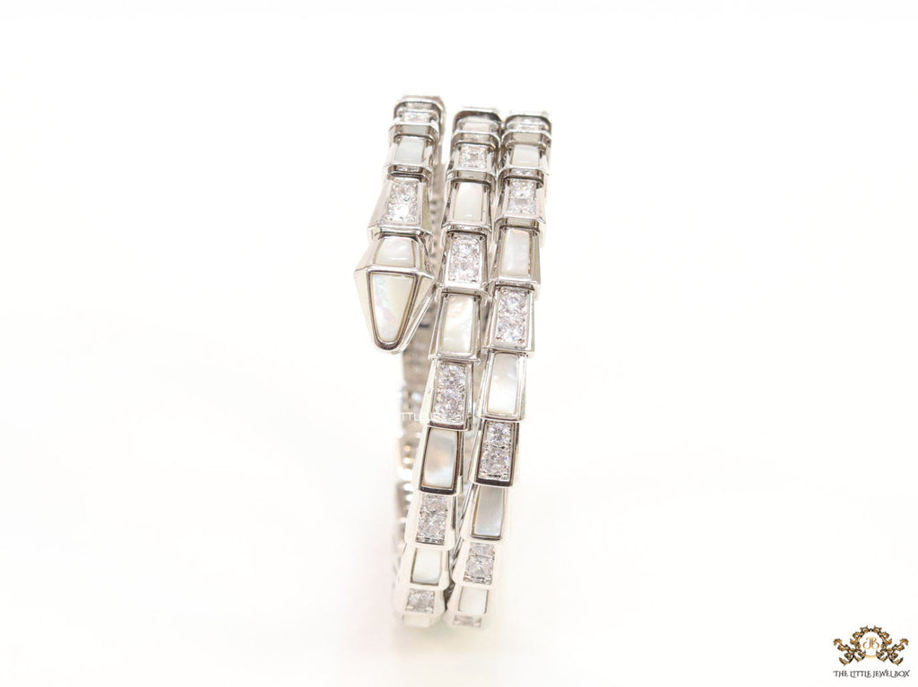 Triple line platinum plated minimal snake bracelet with cubic zirconia stones and pearl white stones.