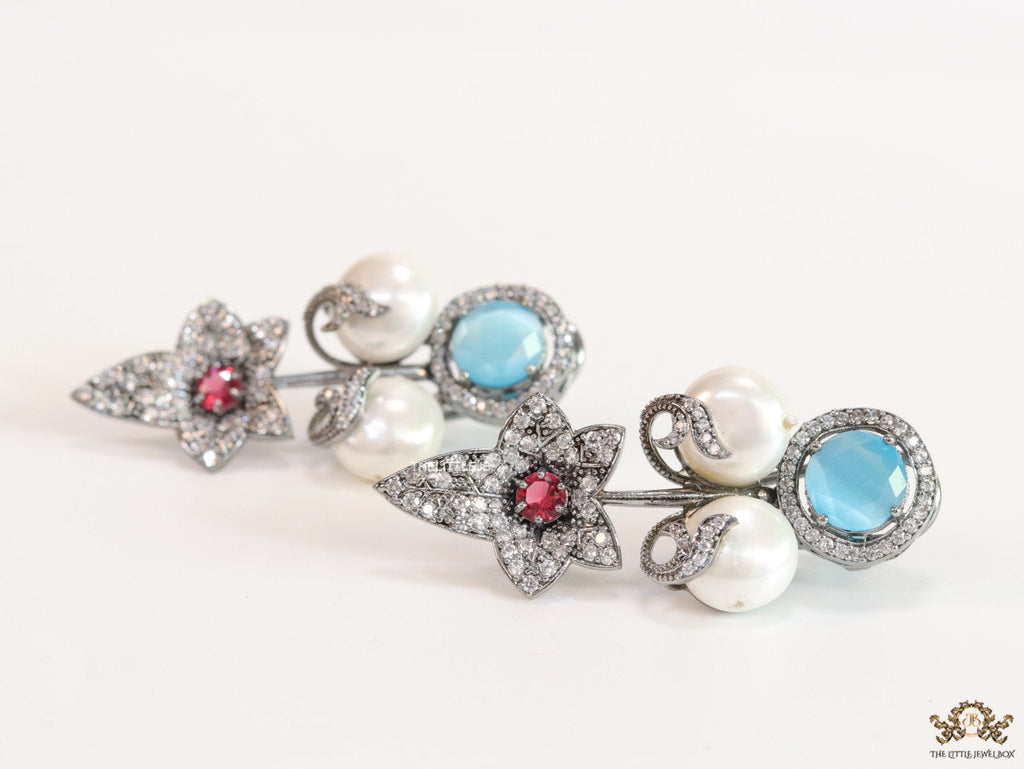 Cz flower earrings with shell pearls and light blue stones