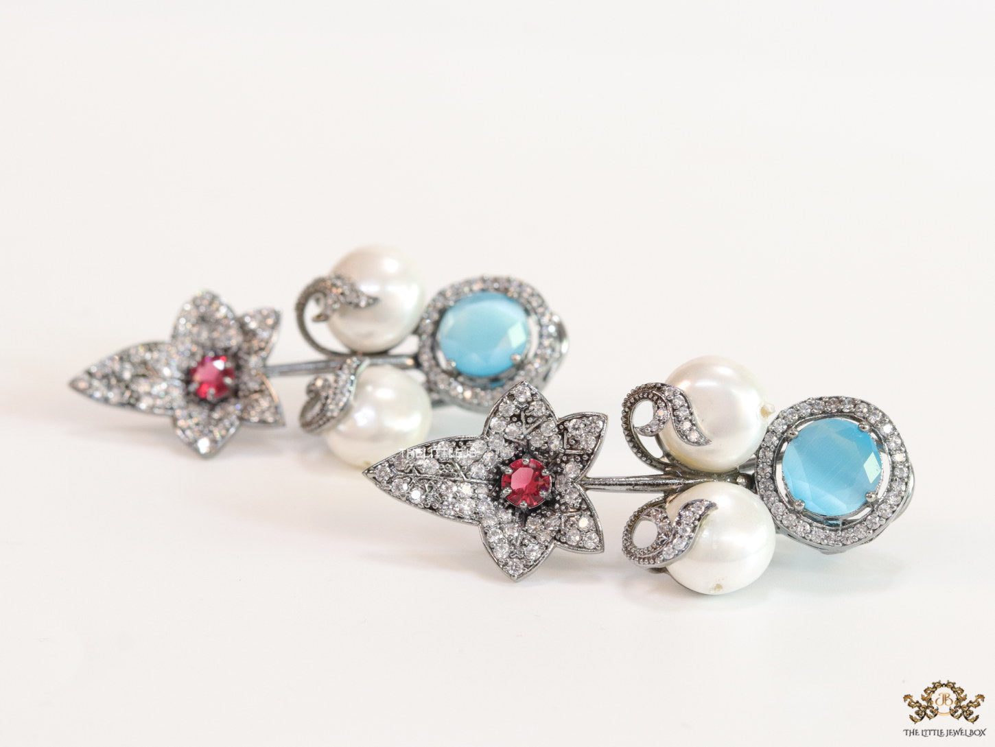 Cz flower earrings with shell pearls and light blue stones