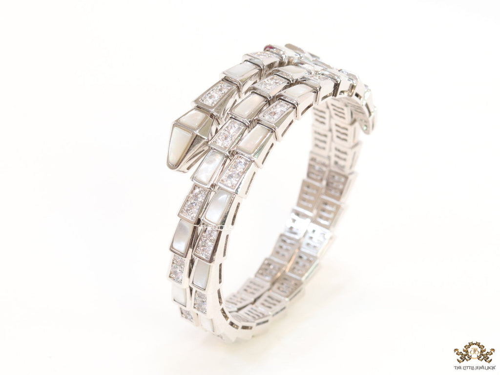 Triple line platinum plated minimal snake bracelet with cubic zirconia stones and pearl white stones.