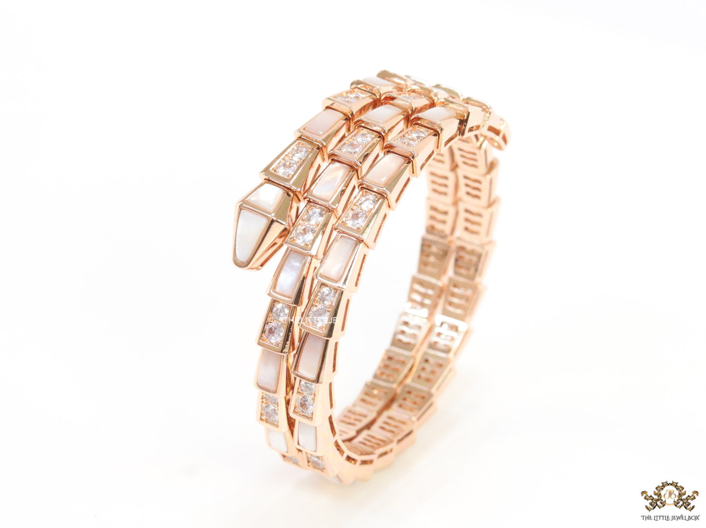 Triple line rose gold plated minimal serpentine bracelet with cubic zirconia stones and pearl white stones.