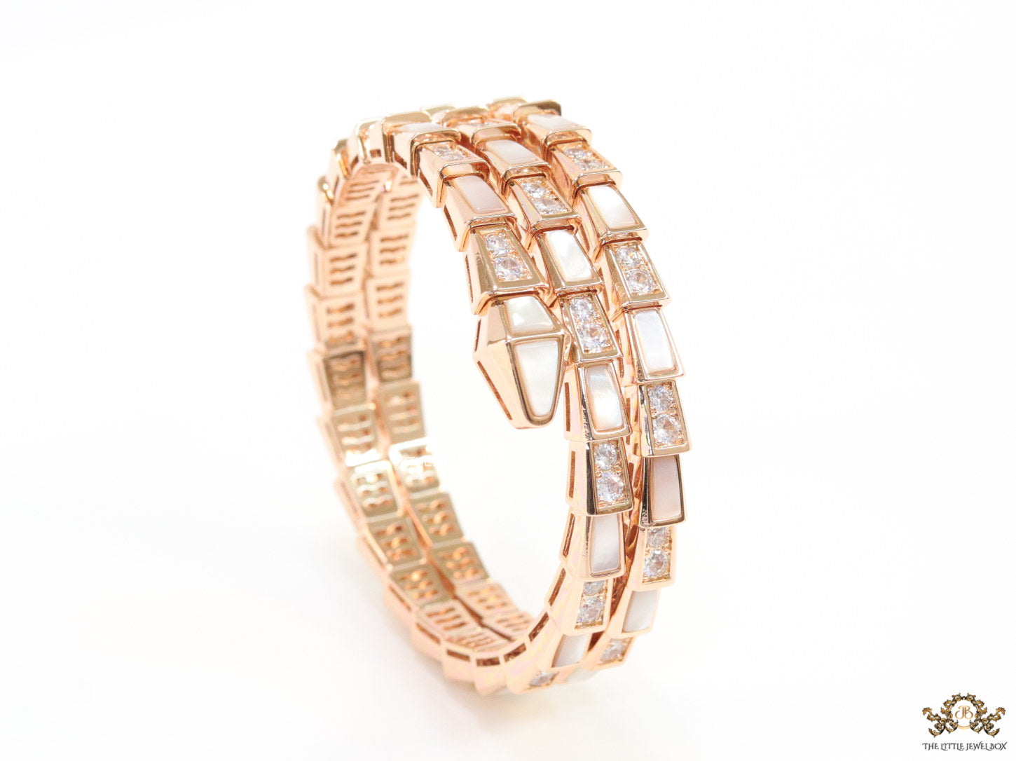 Triple line rose gold plated minimal serpentine bracelet with cubic zirconia stones and pearl white stones.