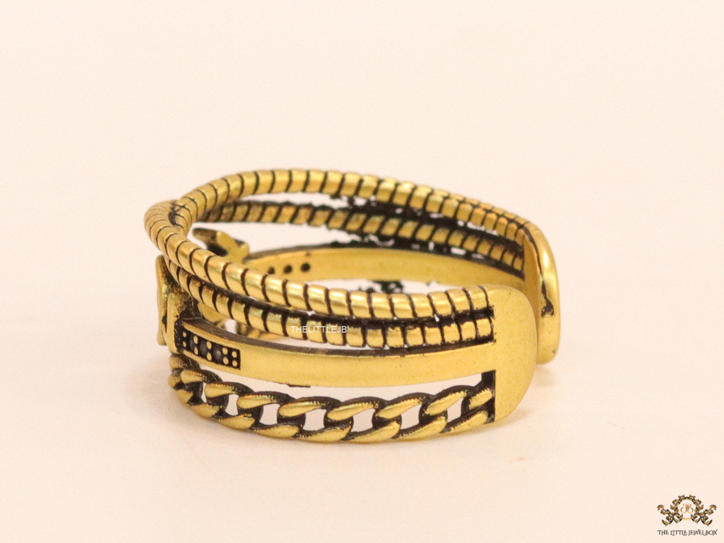 Multilayered open golden ring with alphabet initial