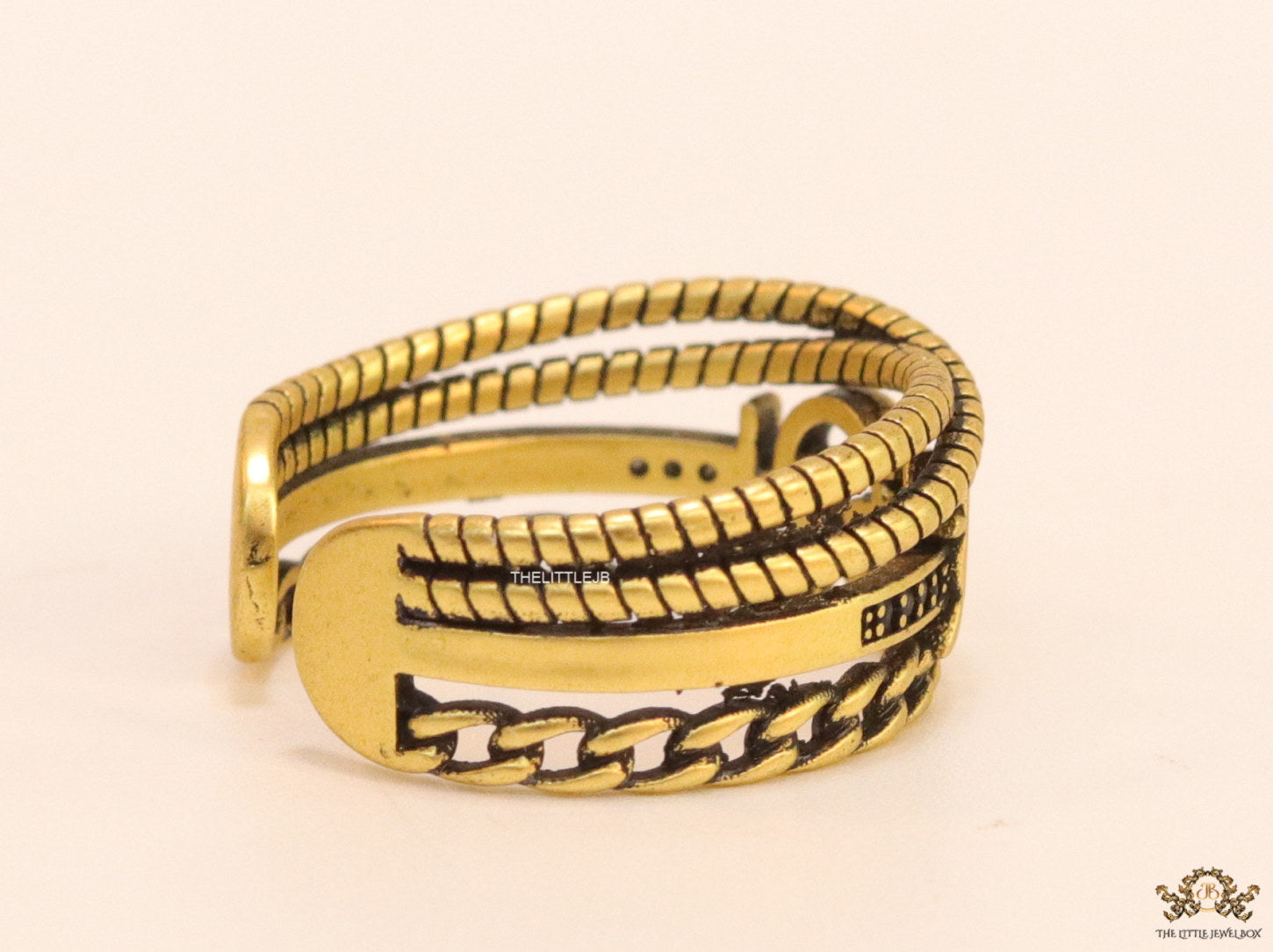 Multilayered open golden ring with alphabet initial