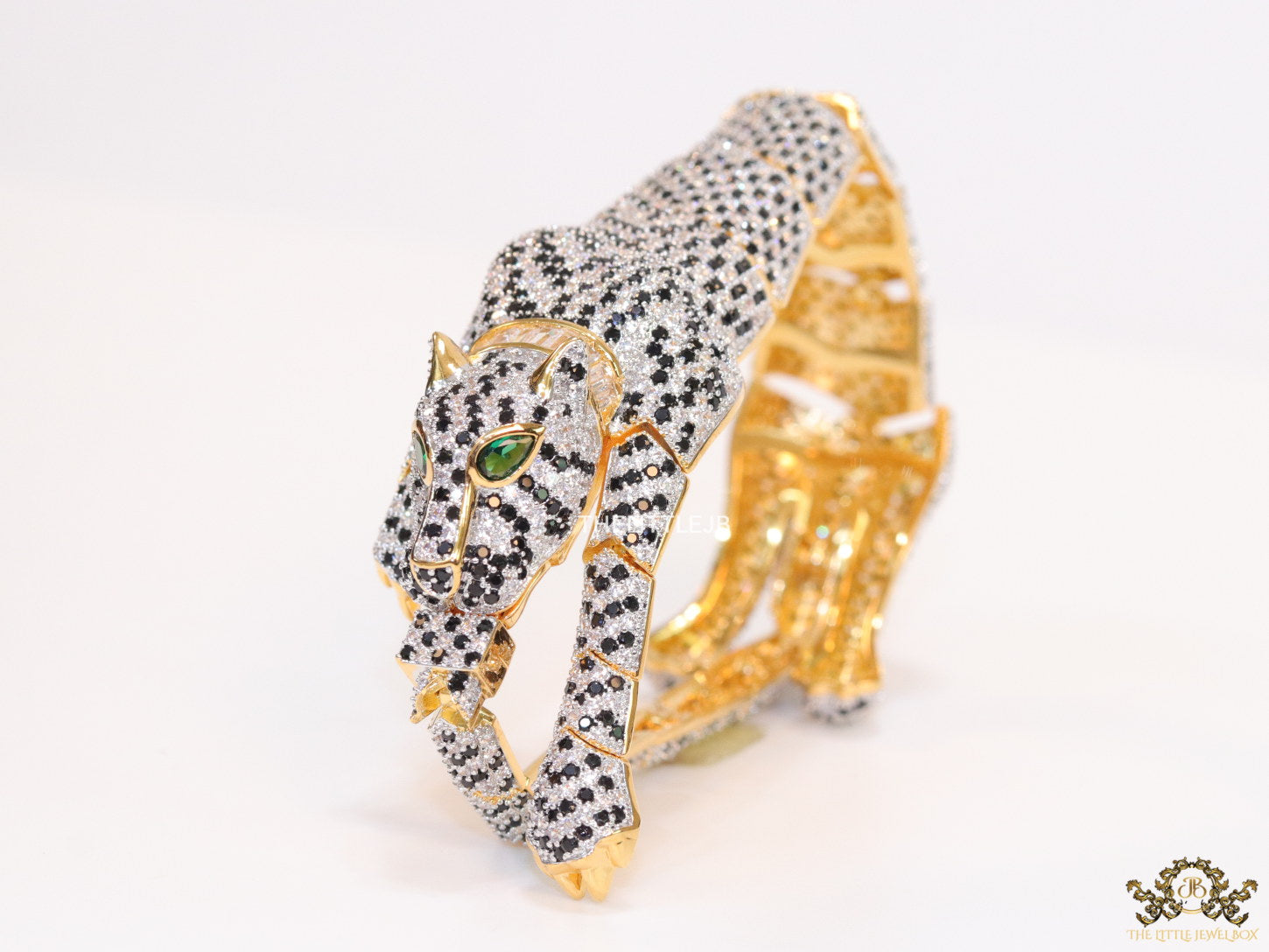 Cubic zirconia stone studded panther motif with emerald green colour stone details gold plated bracelet