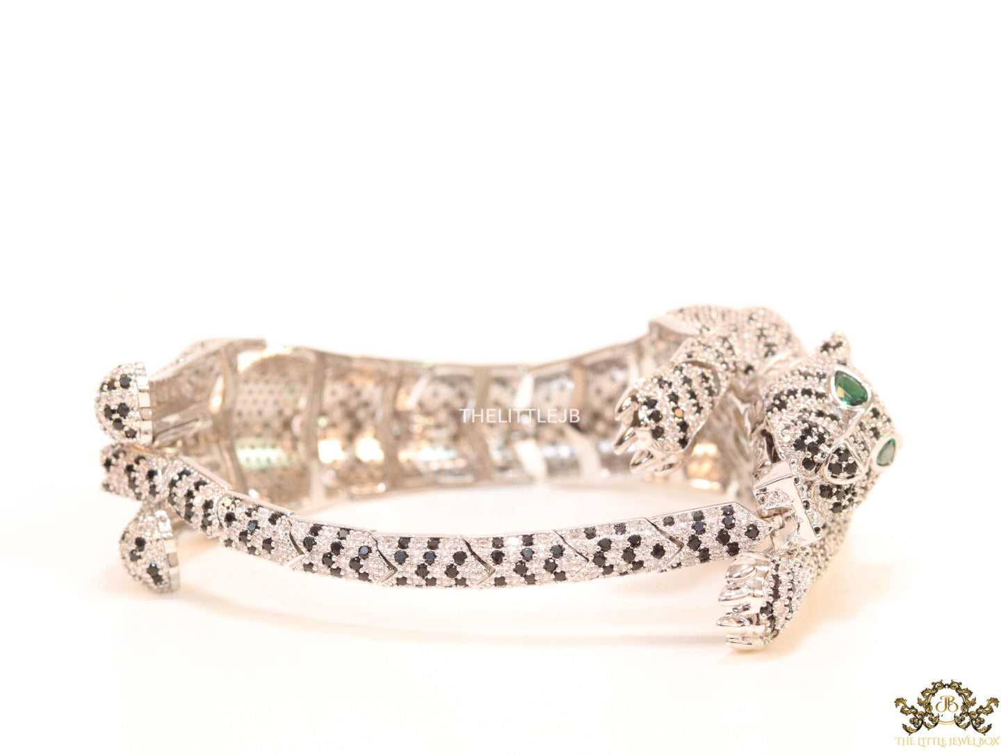 Cubic zirconia stone studded panther motif with emerald green colour stone details platinum plated bracelet