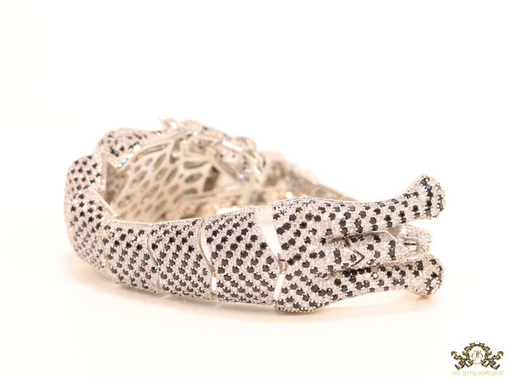Cubic zirconia stone studded panther motif with emerald green colour stone details platinum plated bracelet