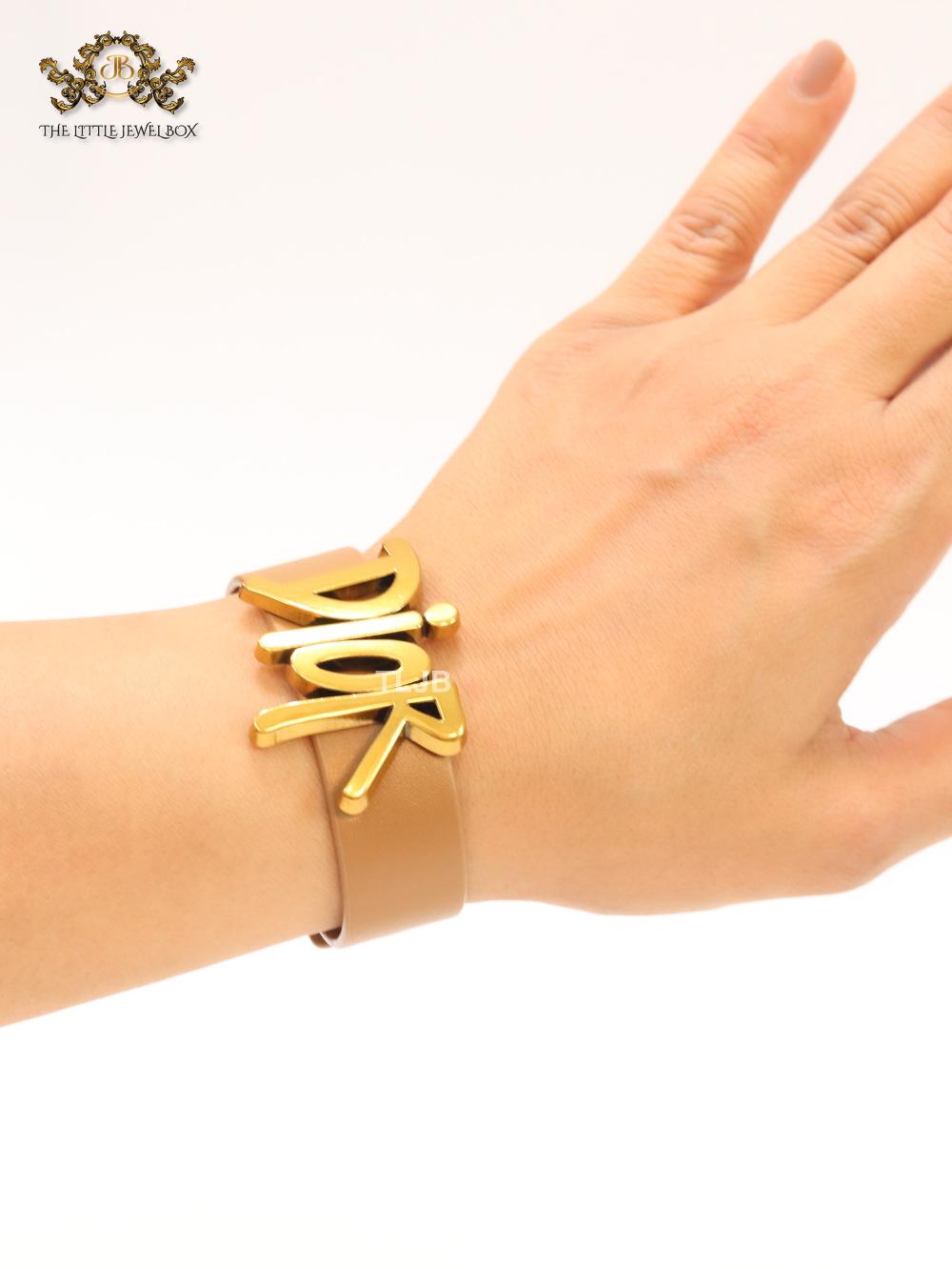 Alphabet D and tan belted bracelet