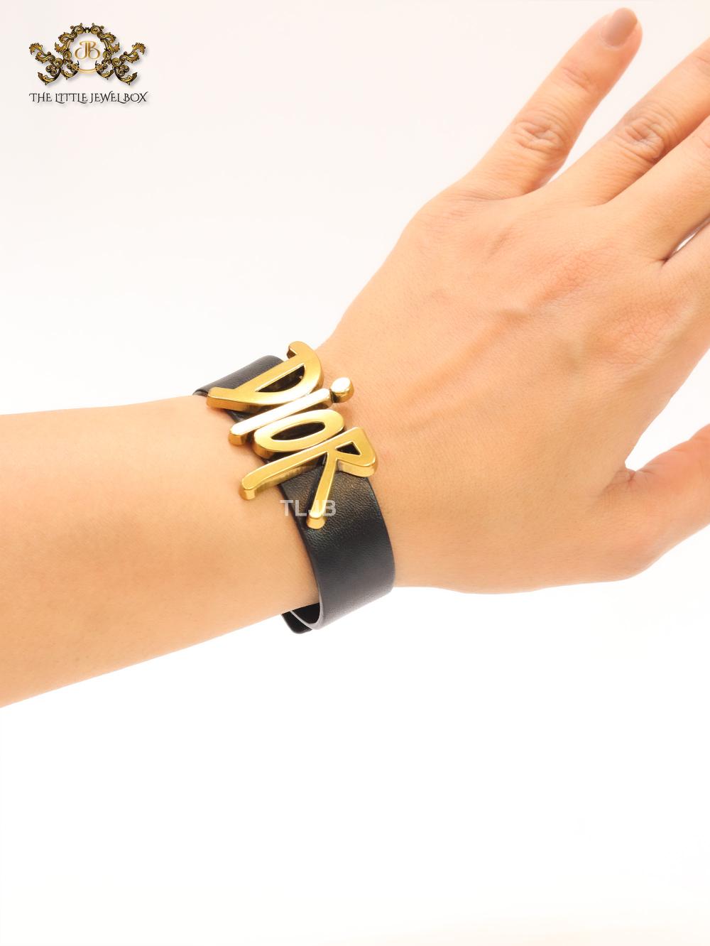 Alphabet D and black belted bracelet