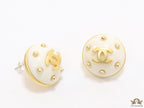White and golden round studs with twin C motif
