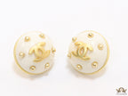 White and golden round studs with twin C motif