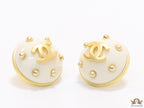 White and golden round studs with twin C motif