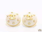 White and golden round studs with twin C motif