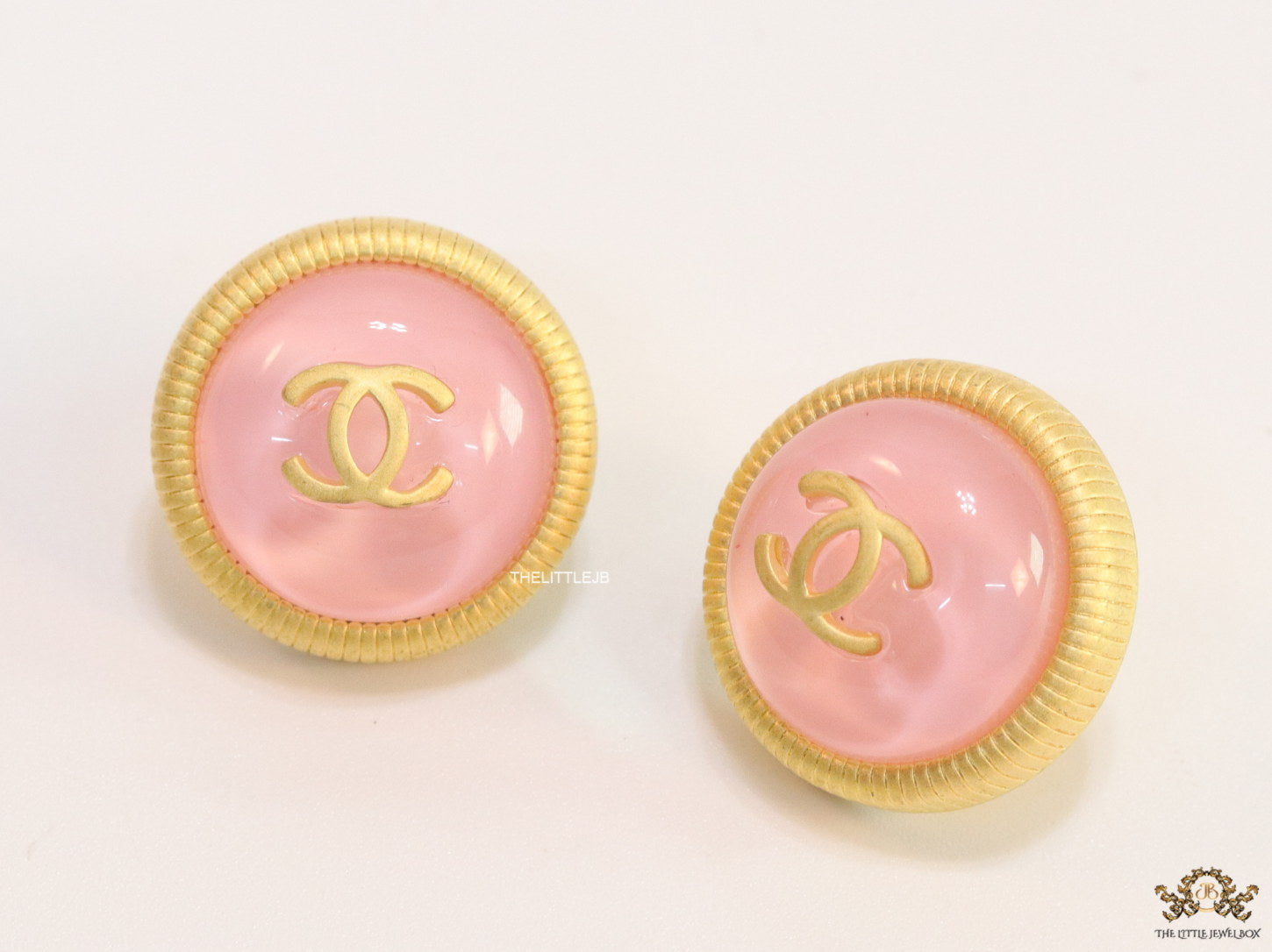 Pink and golden round studs with twin C motif