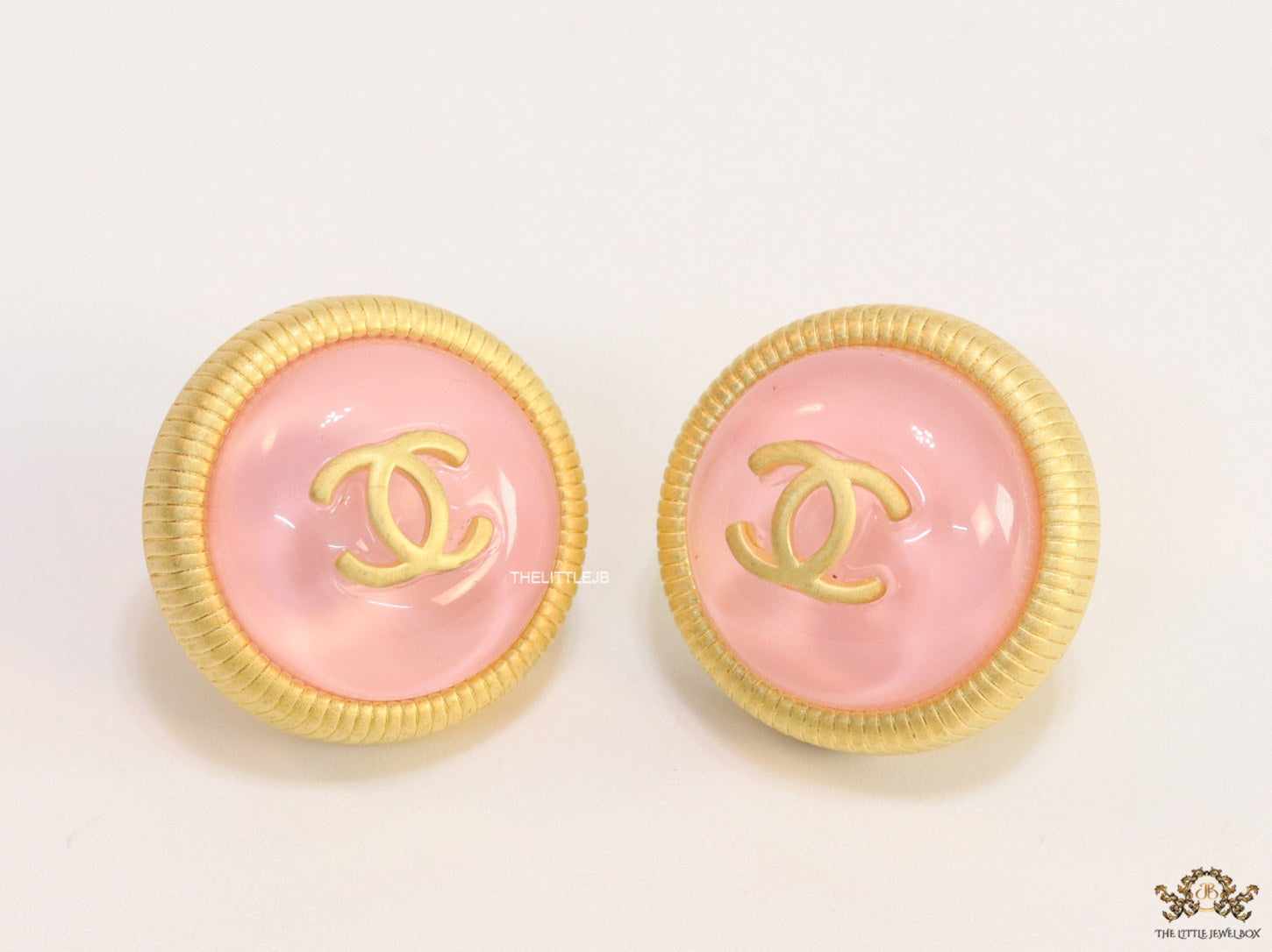 Pink and golden round studs with twin C motif