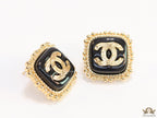 Square black and golden stud earrings with golden twin C motifs