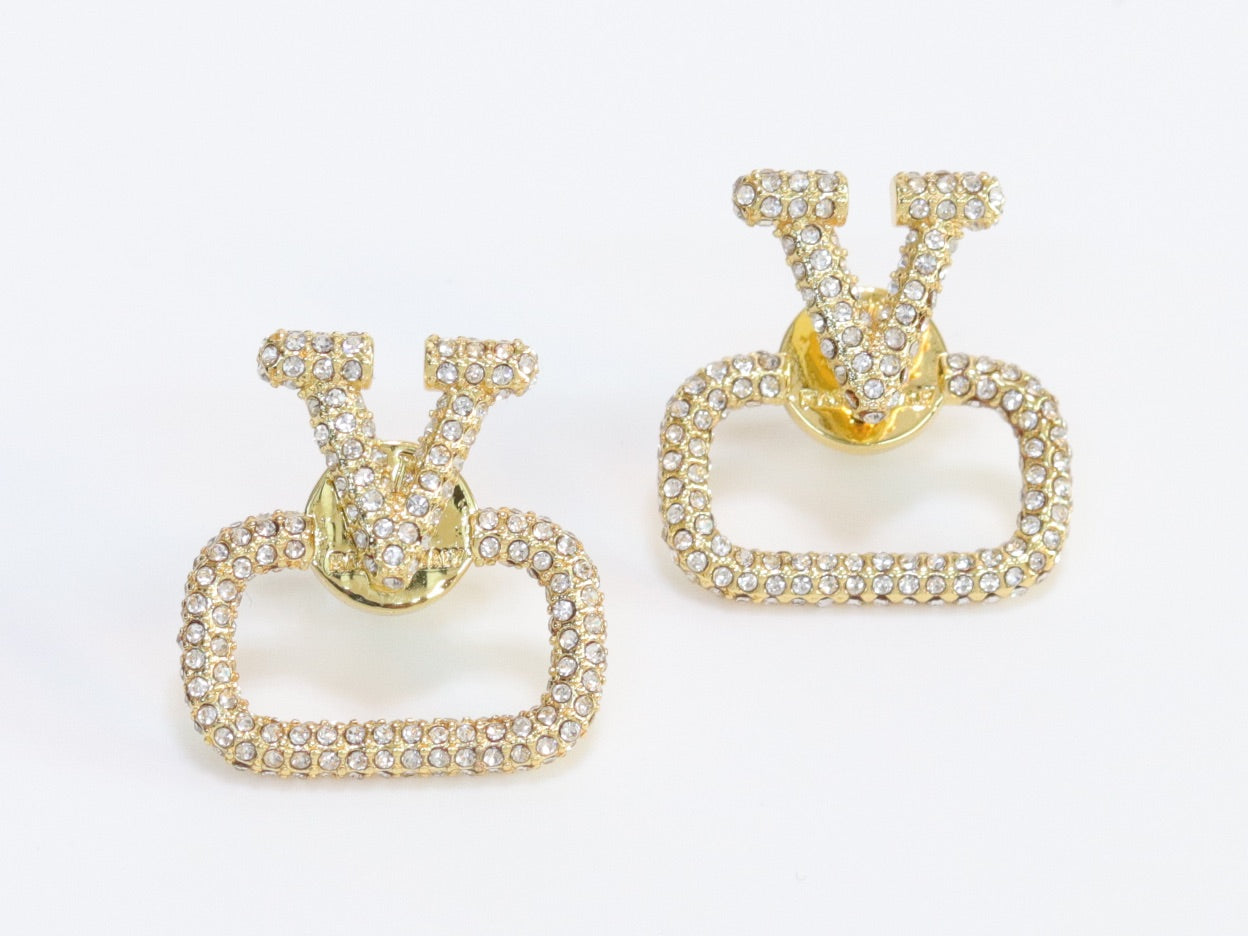 Alphabet V cz studs in gold finish