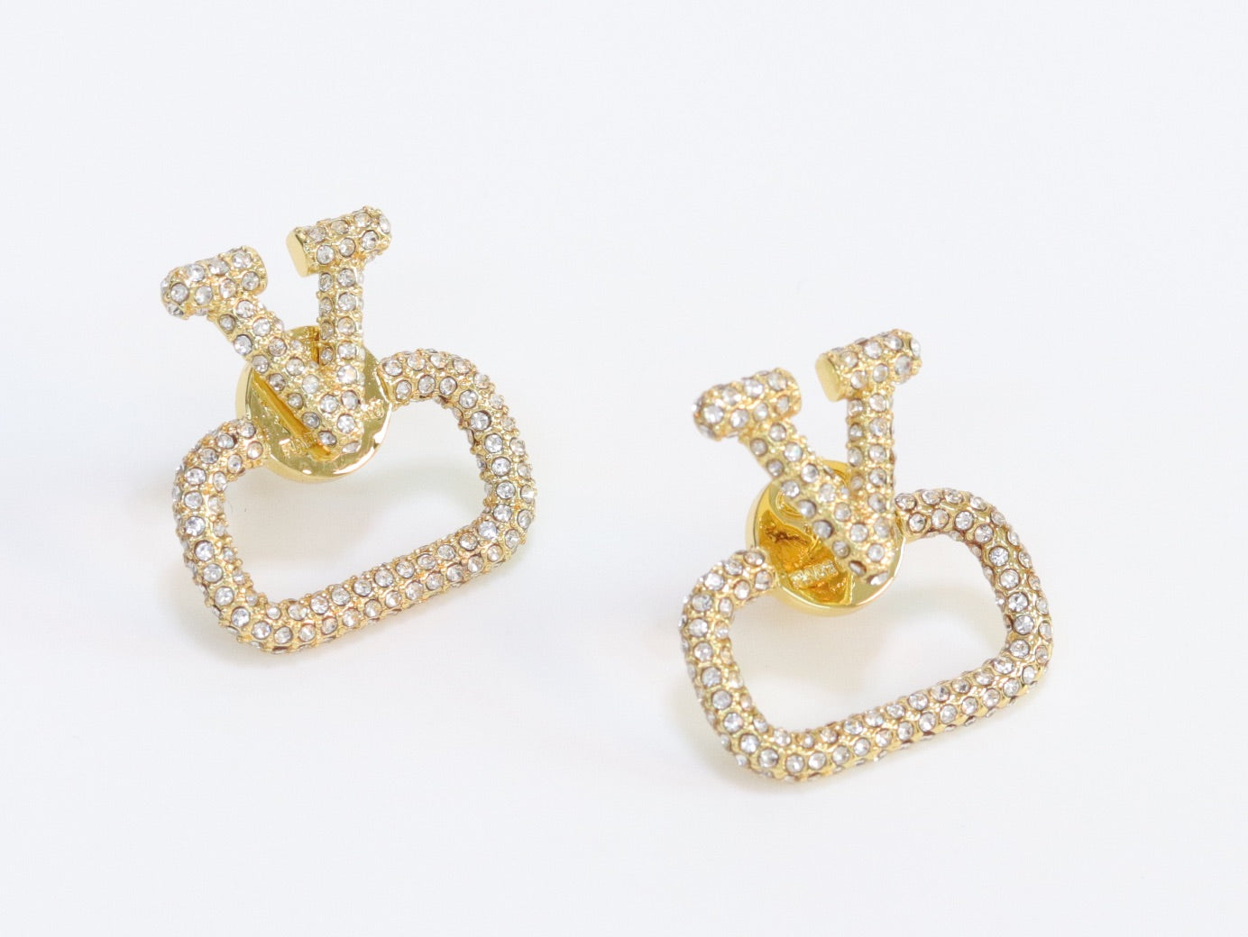 Alphabet V cz studs in gold finish