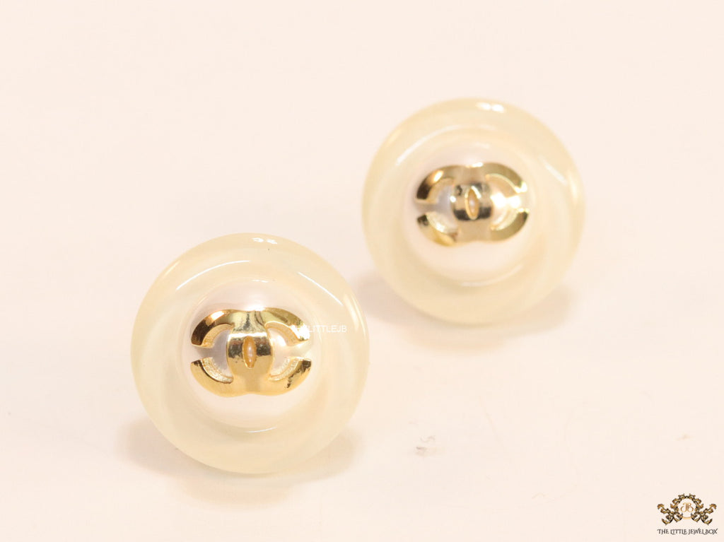 White acrylic studs with pearl and twin C motif