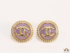 Twin C motif gold plated round studs on lilac acrylic base