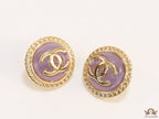 Twin C motif gold plated round studs on lilac acrylic base