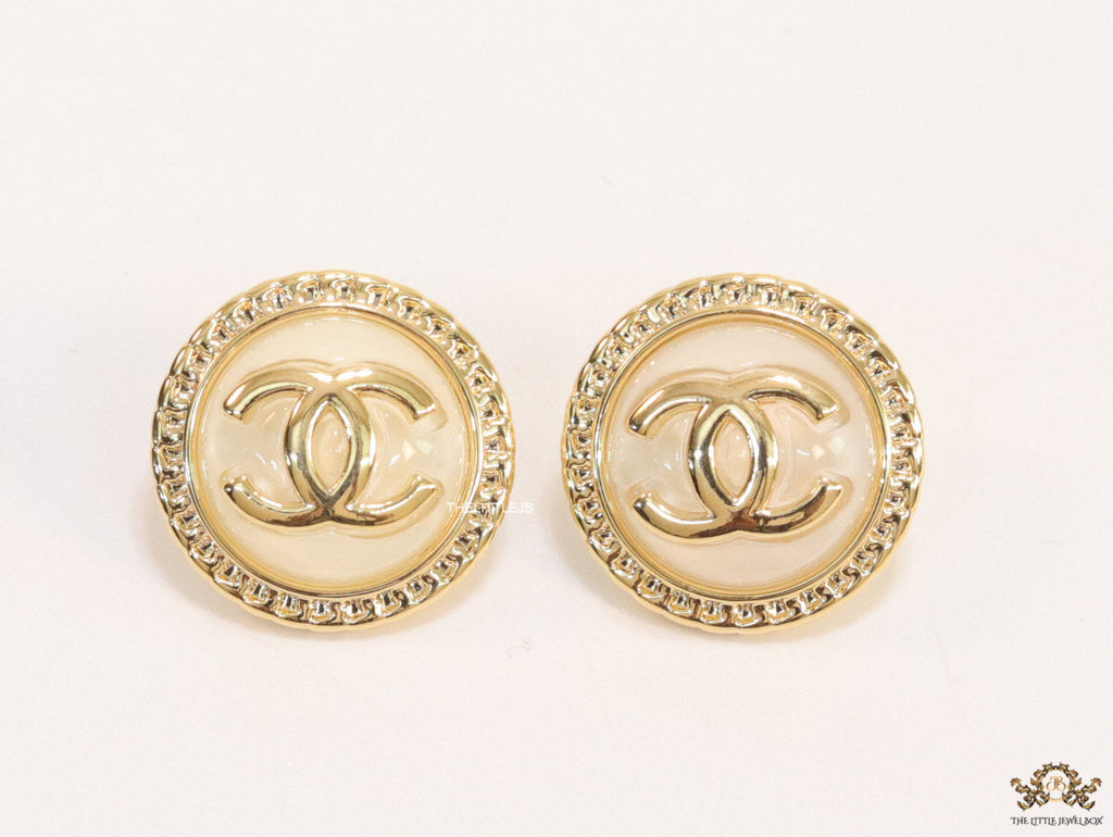 Twin C motif gold plated round studs on pearly cream acrylic base