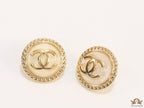 Twin C motif gold plated round studs on pearly cream acrylic base