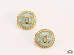 Twin C motif gold plated round studs on mint green acrylic base