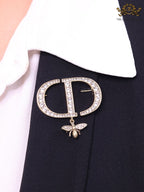 Alphabet C and D brooch in gold finish with dragonfly and cz