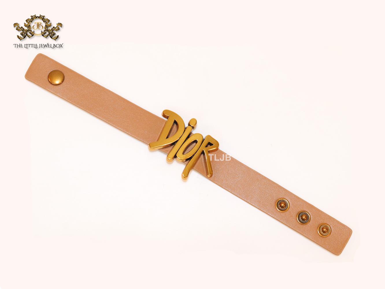 Alphabet D and tan belted bracelet
