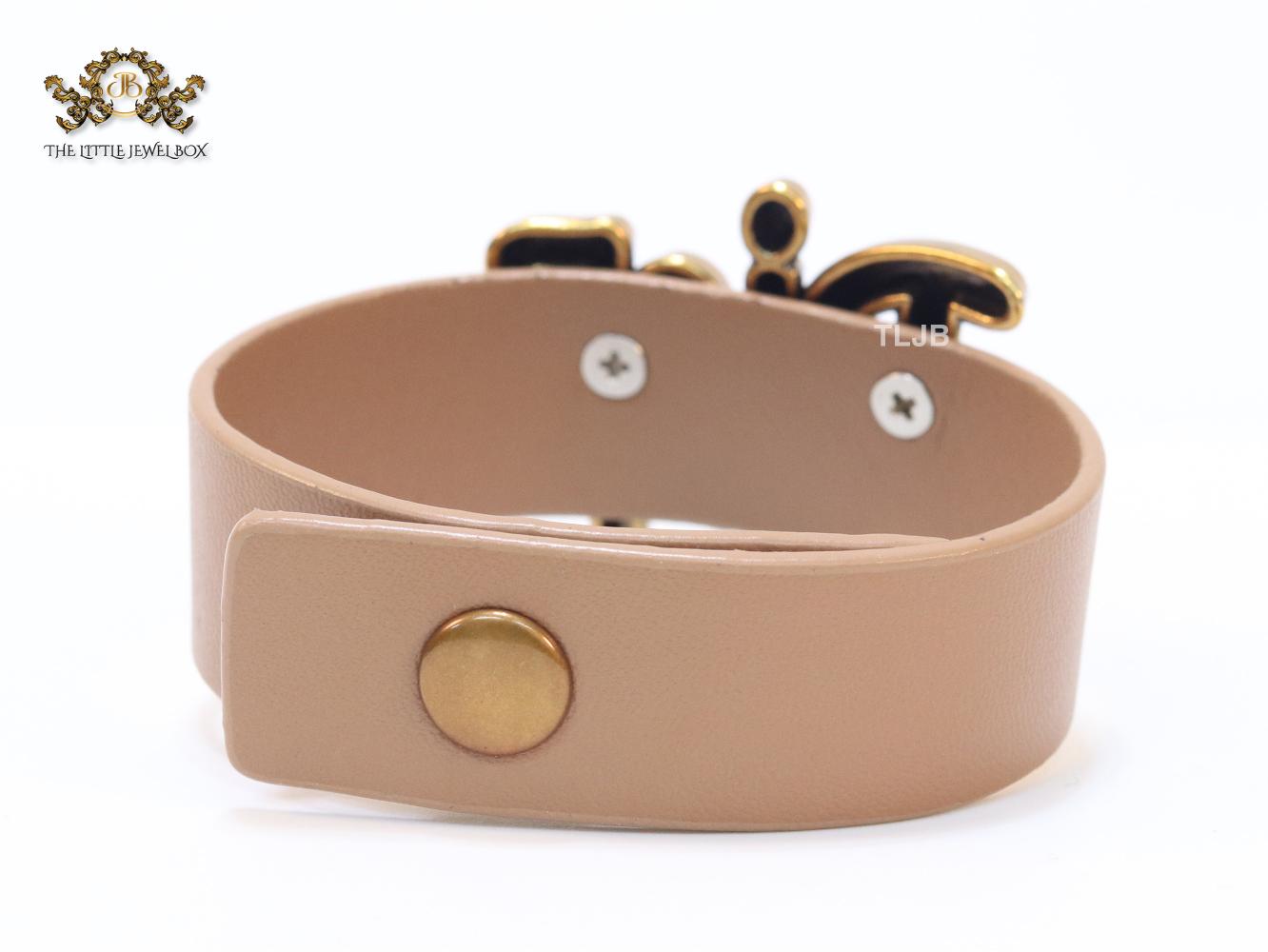 Alphabet D and tan belted bracelet