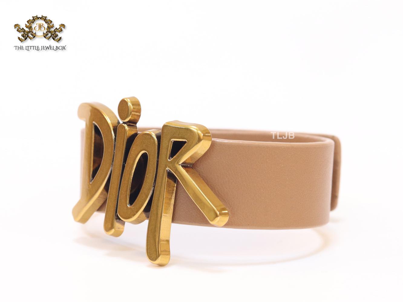 Alphabet D and tan belted bracelet