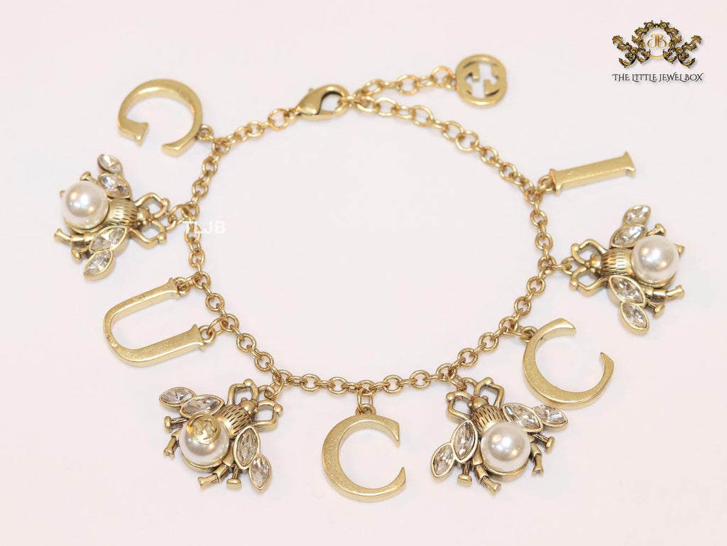 Double G bracelet with rustic charms bracelet