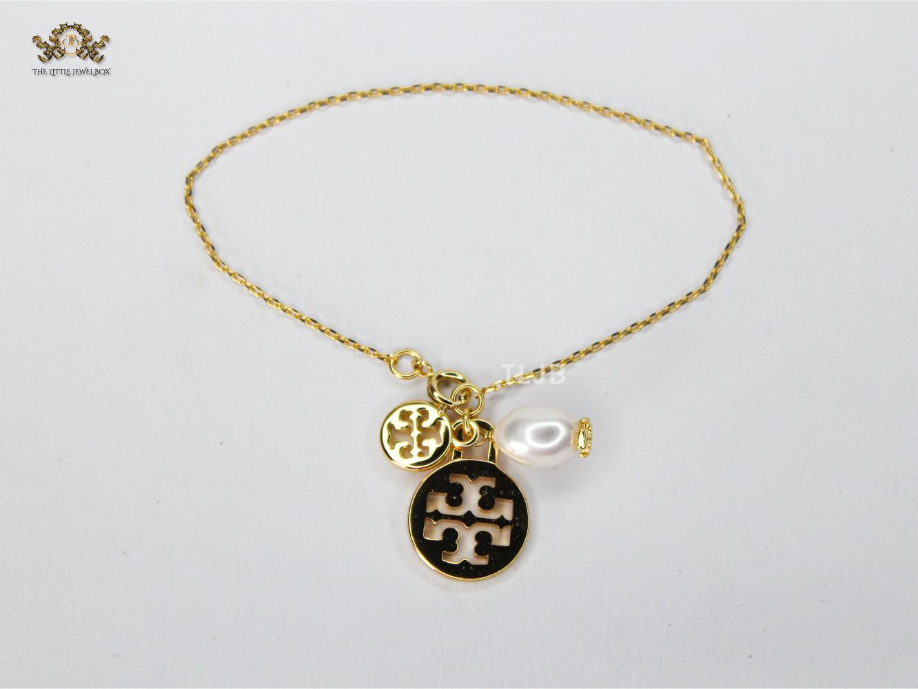 Three charm gold toned bracelet