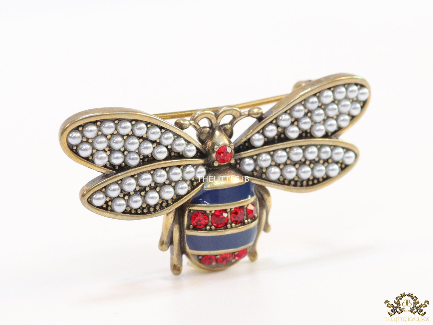 Antique gold finish bee brooch with white and red stones and blue details