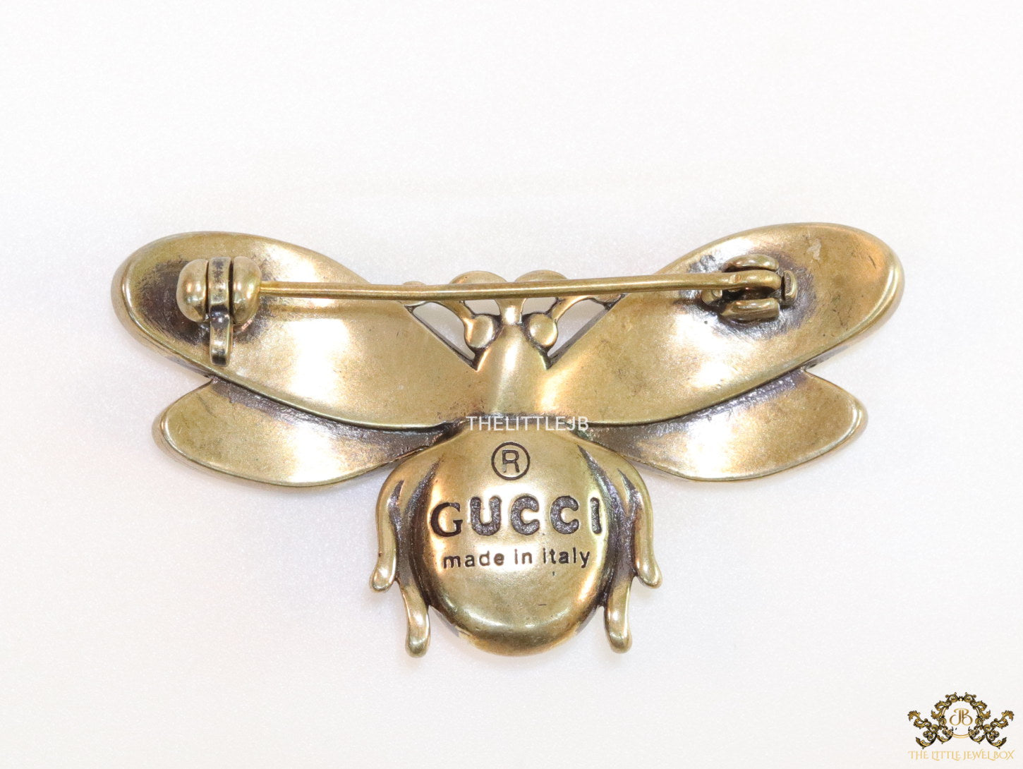 Antique gold finish bee brooch with white and red stones and blue details