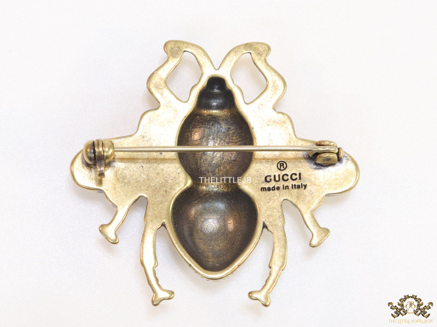 Antique gold finish bee brooch with white and red stones and blue details