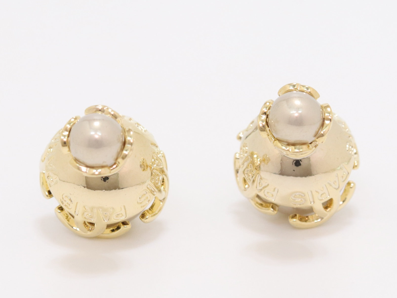 Double C beige pearl studs in gold finish