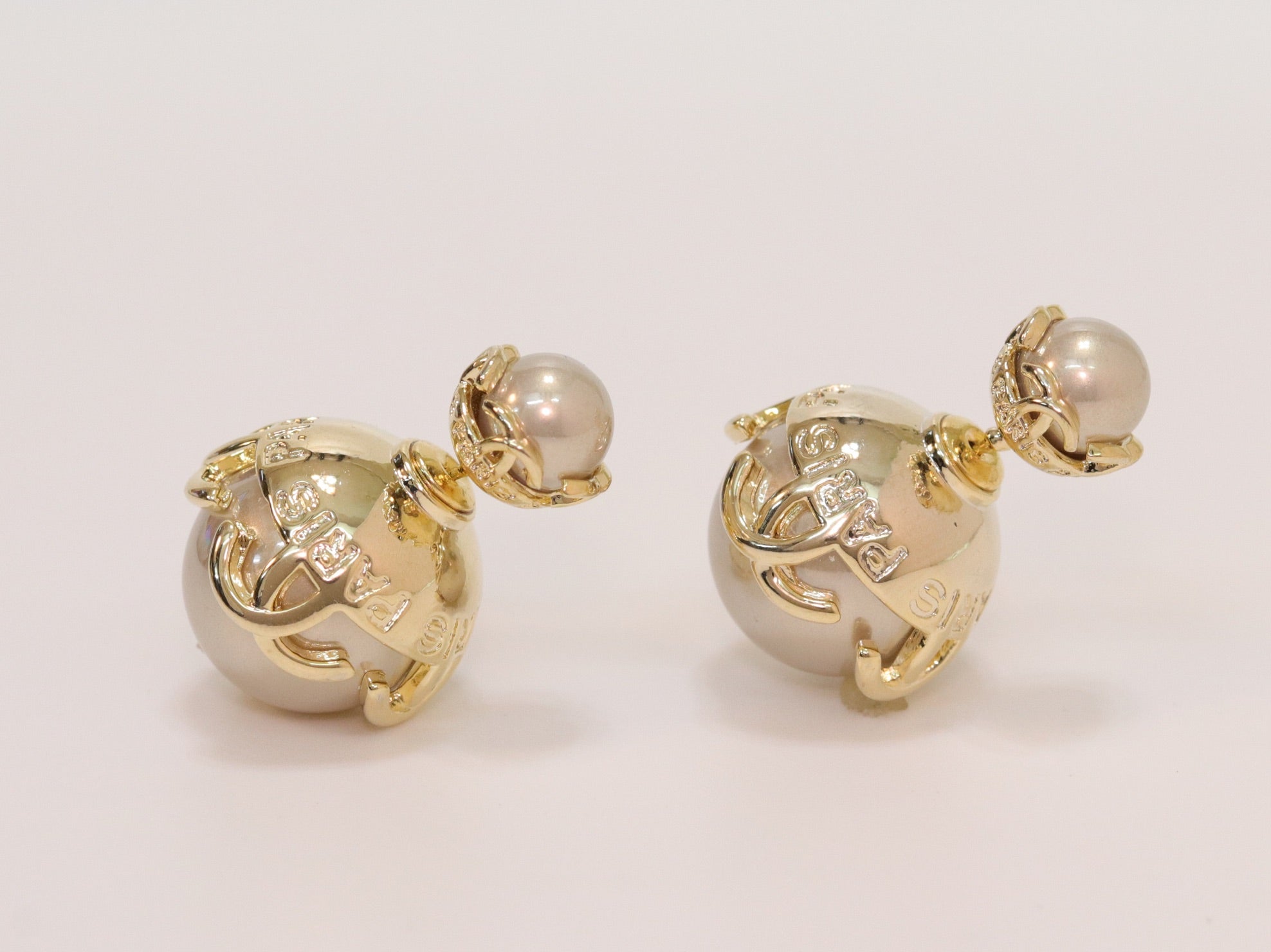 Double C beige pearl studs in gold finish