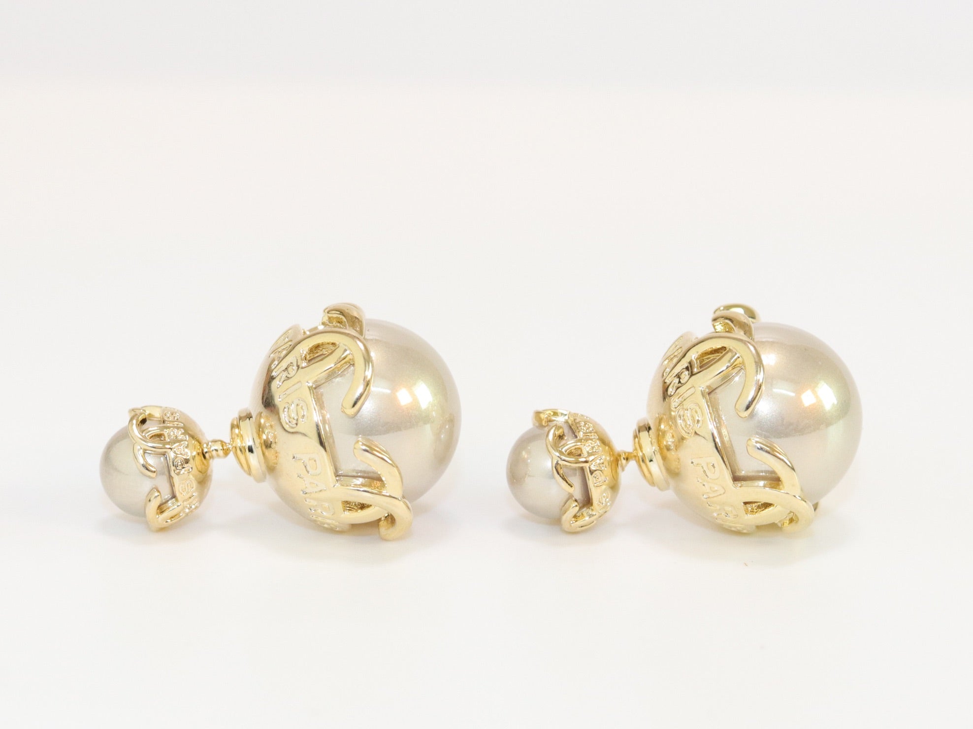 Double C beige pearl studs in gold finish