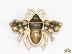 Antique gold finish double G bee brooch with blue details and white and red stones